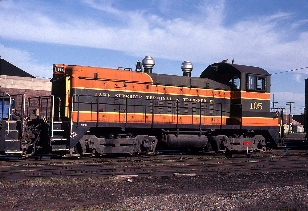 Diesel locomotive single order units: Orange and brown locomotive with twin onion-dome exhaust stacks in line.