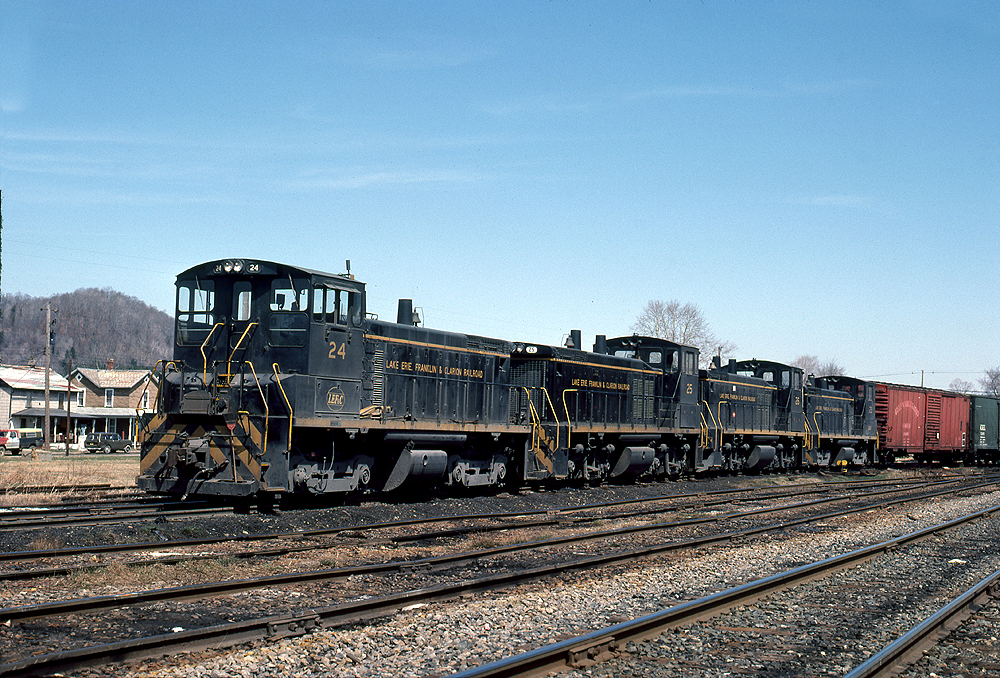 Black and yellow-accented locomotives in a string. Diesel locomotive single order units.