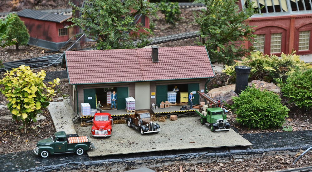 Model warehouse with vehicles parked nearby