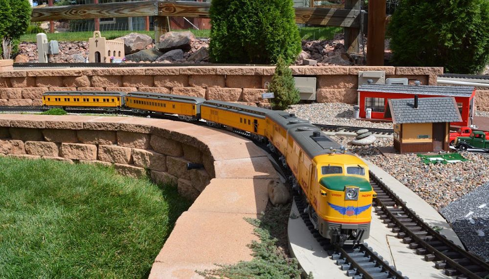 Diesel locomotive approaches on garden railway