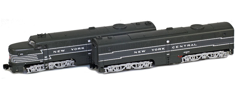 Photo of Z scale locomotives painted two-tone gray with silver trucks.