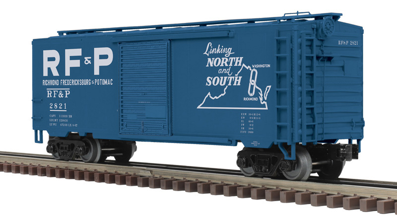 Photo of O scale boxcar painted dark blue with white graphics.
