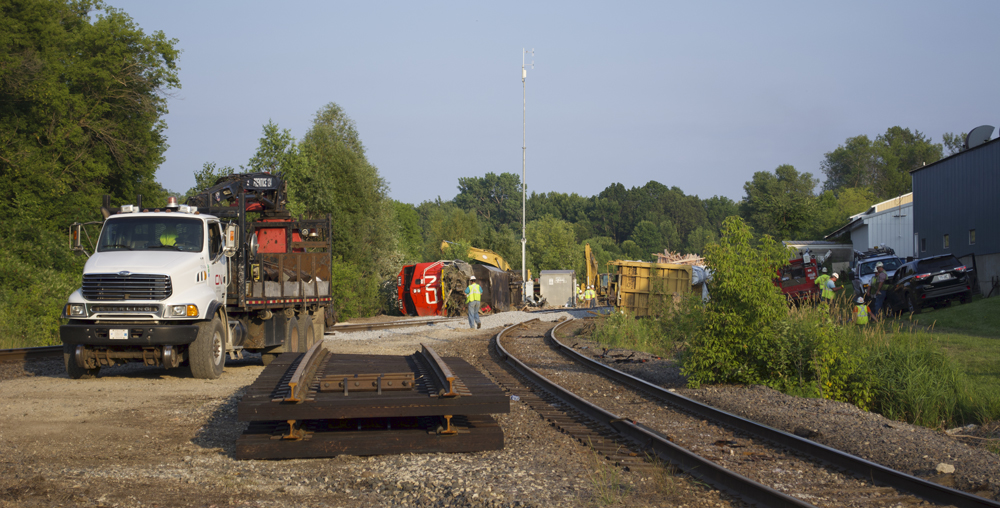 Photo of derailment site with trucks and panel track