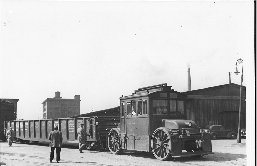 Antique Trackmobiles in railroading: black and white image of traction engine moving freight cars.