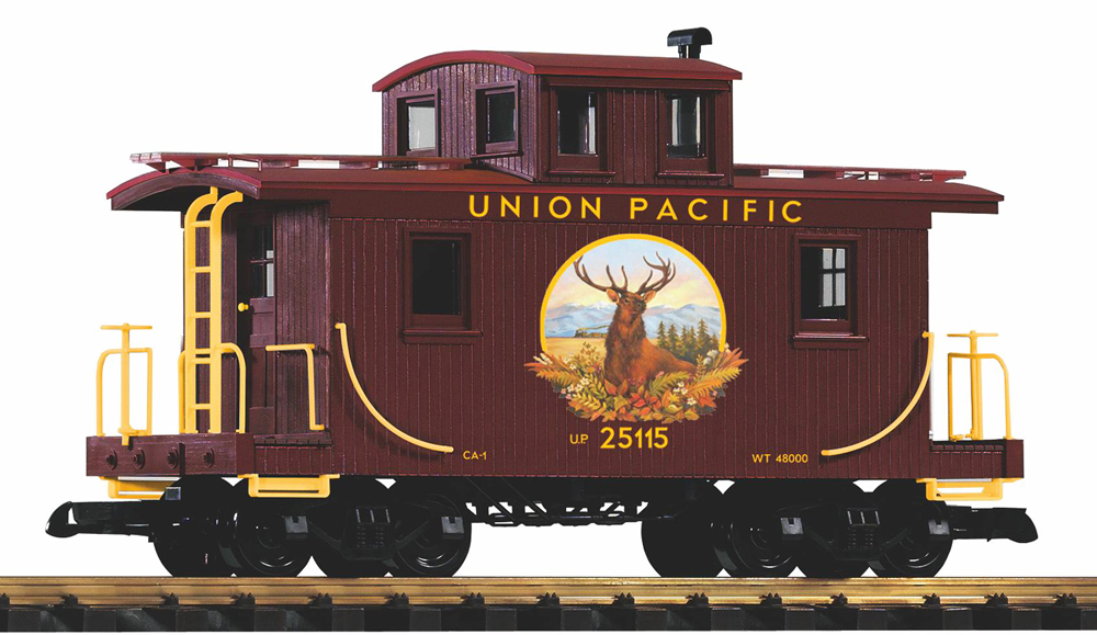 Photo of large scale double-sheathed center-cupola caboose with yellow graphics and elk painting on side on white background. 