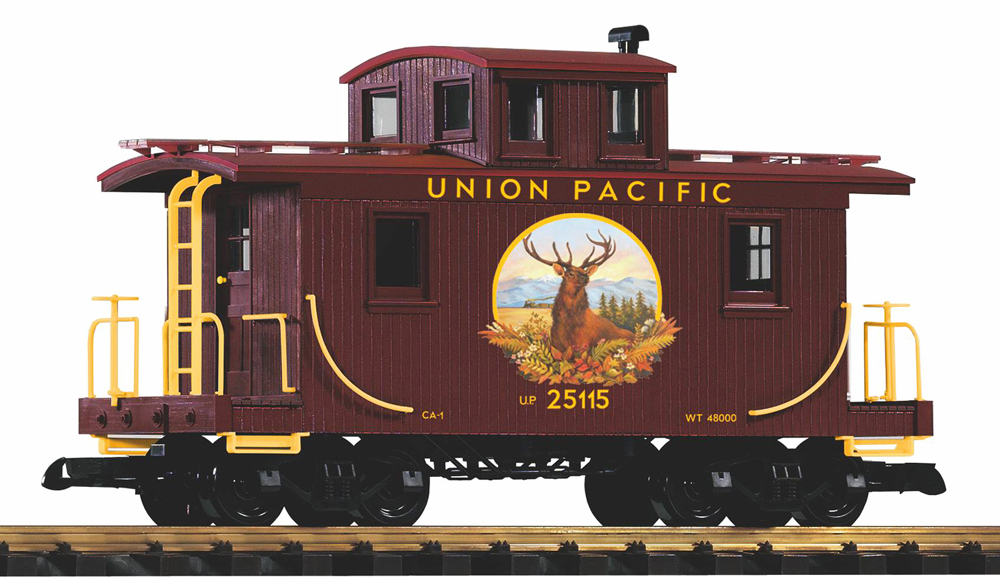Photo of large scale double-sheathed center-cupola caboose with yellow graphics and elk painting on side on white background.