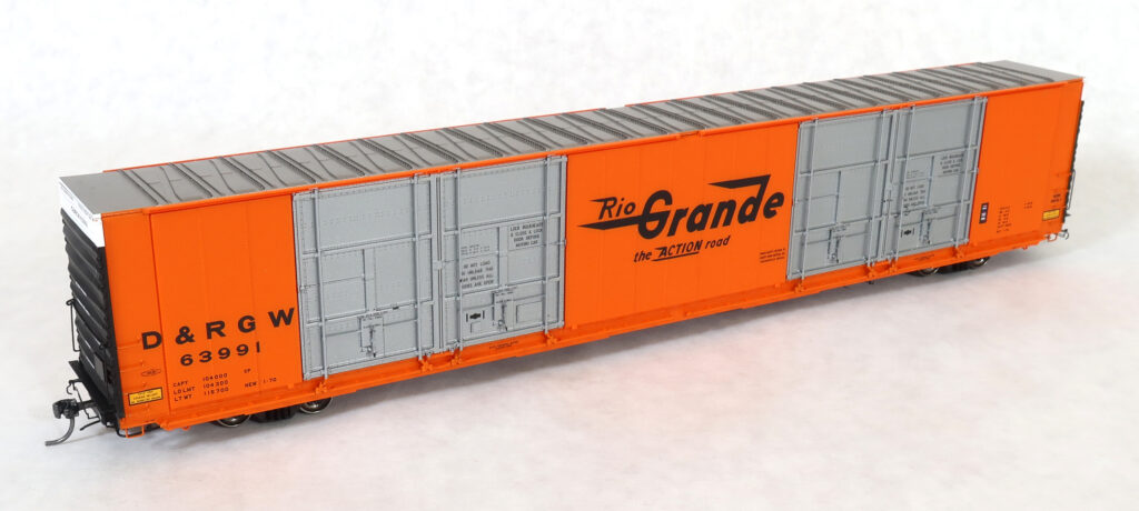 Photo of HO scale Greenville 86-foot quad-door boxcar painted orange, silver, black, and white with black graphics.