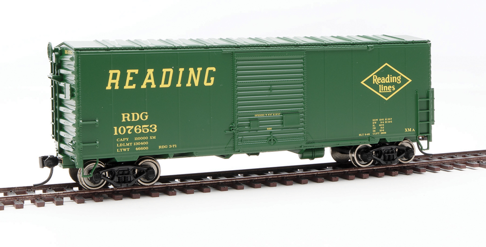 HO scale boxcar painted dark green with yellow graphics.