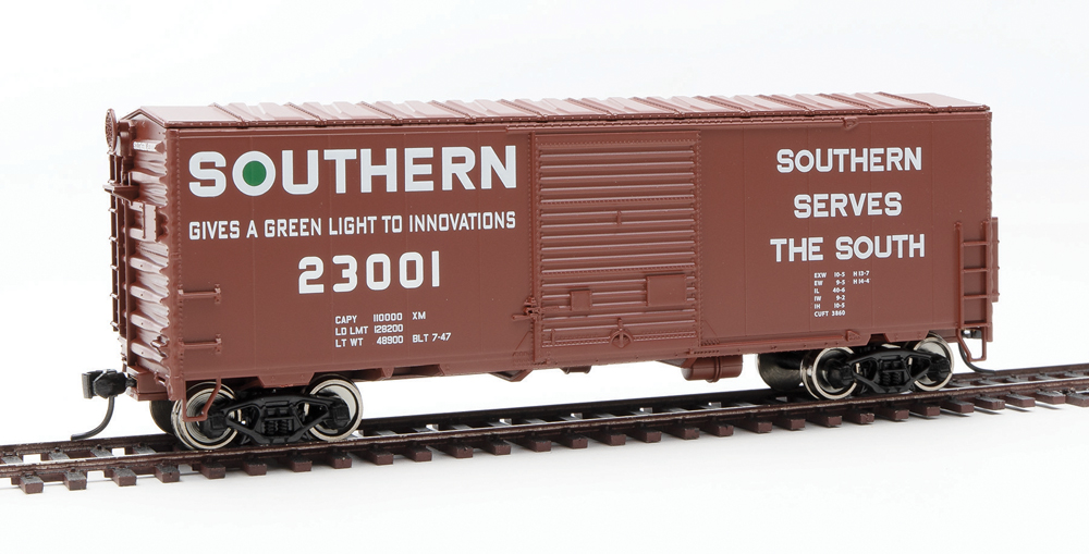 HO scale boxcar painted boxcar red with white and green graphics.