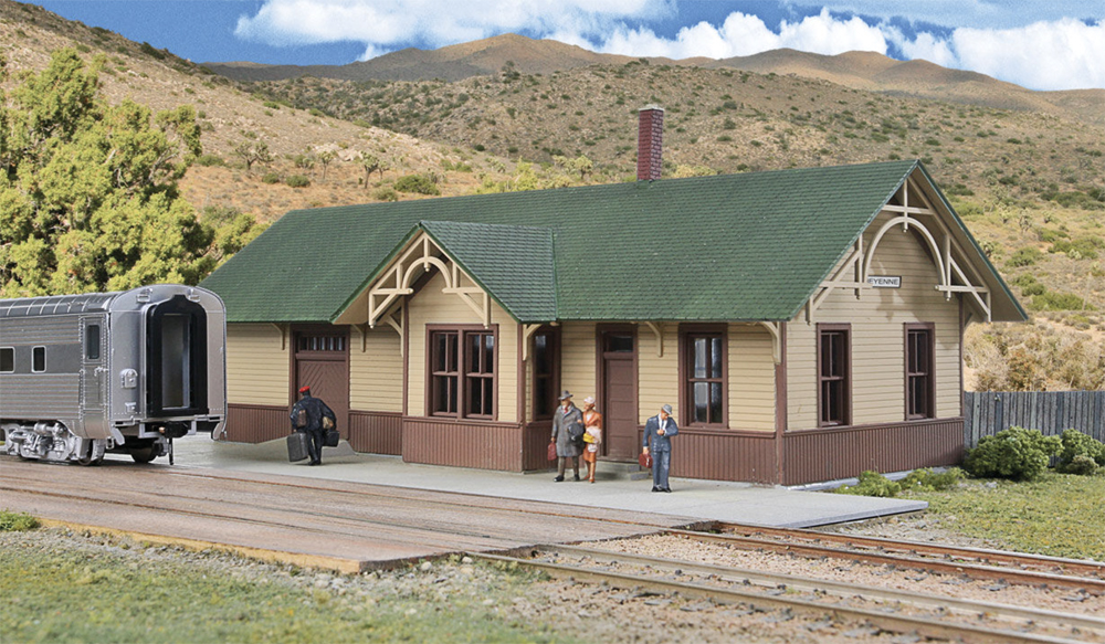 A Walthers HO scale Union Pacific-Style Depot with a train and small-scale figures.