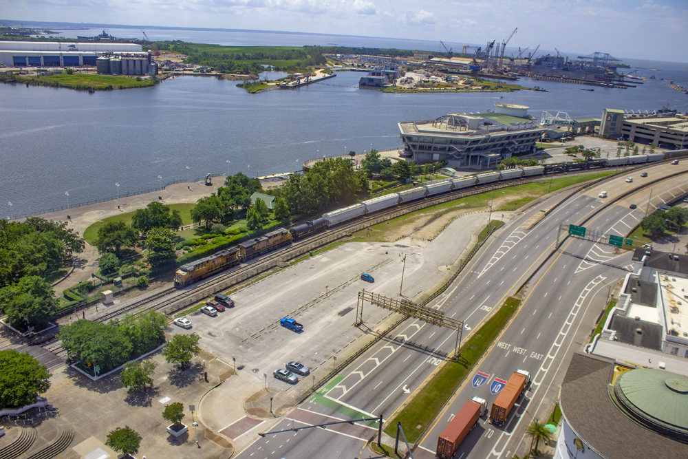 aerial view of land along railroad tracks near water