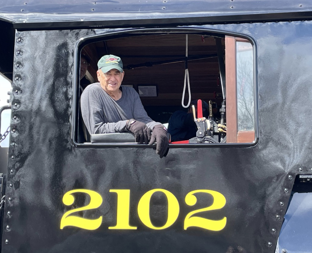 Man in cab of steam locomotive