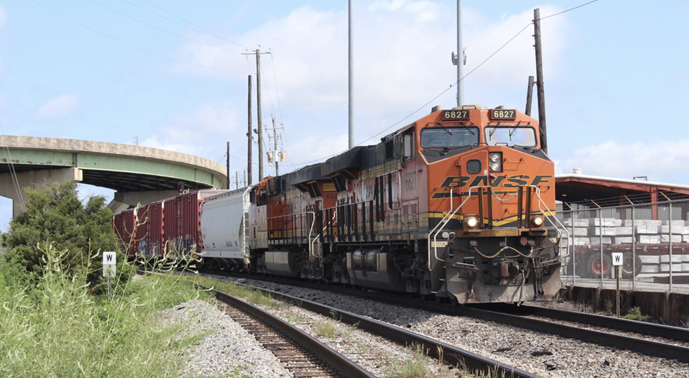 Freight train with BNSF engines on one of two mainline tracks