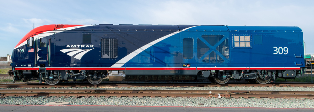 Side view of red, dark blue, and medium blue locomotive