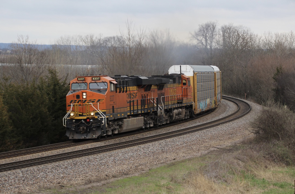 Orange and black locomotives on freight train