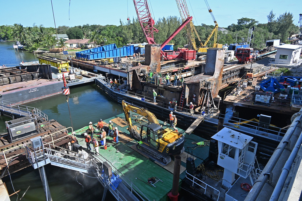 Construction equipment at bridge on river