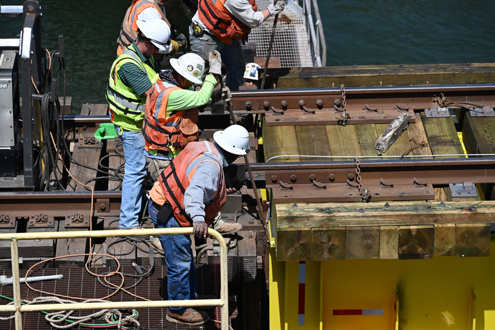 Construction workers on railroad bridge