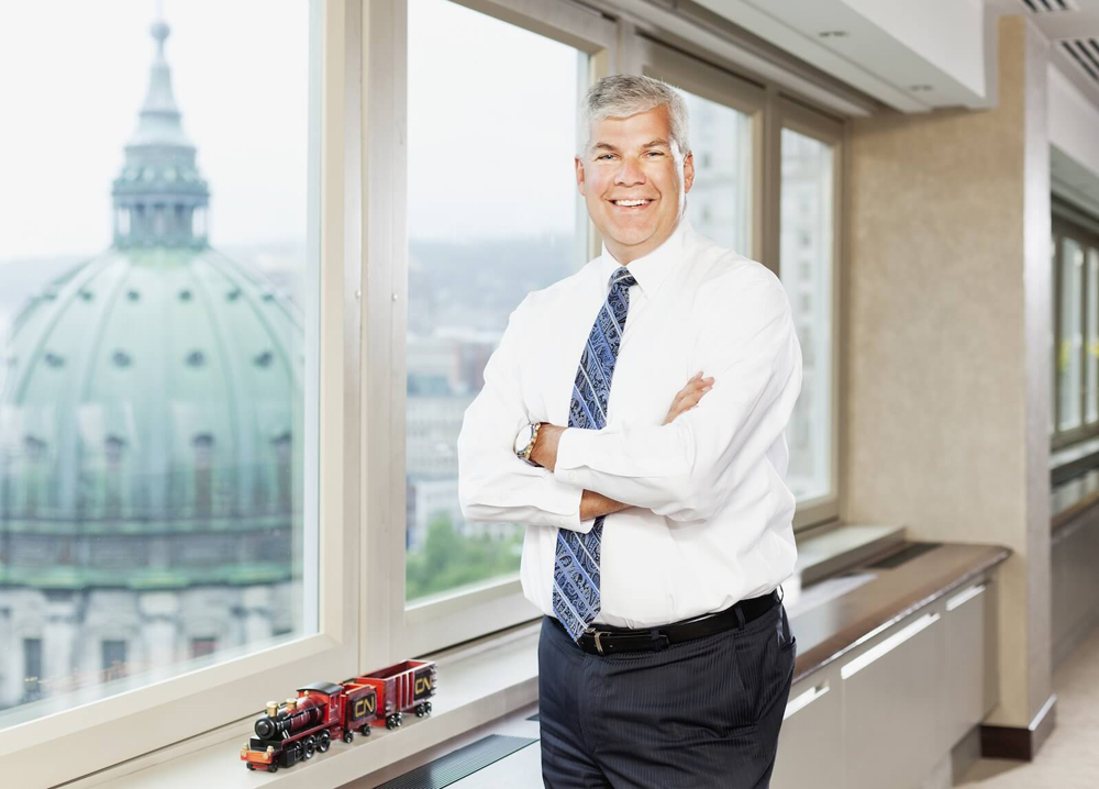 Man in white shirrt and tie next to window