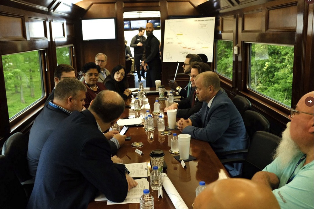 People talking at table on board passenger car