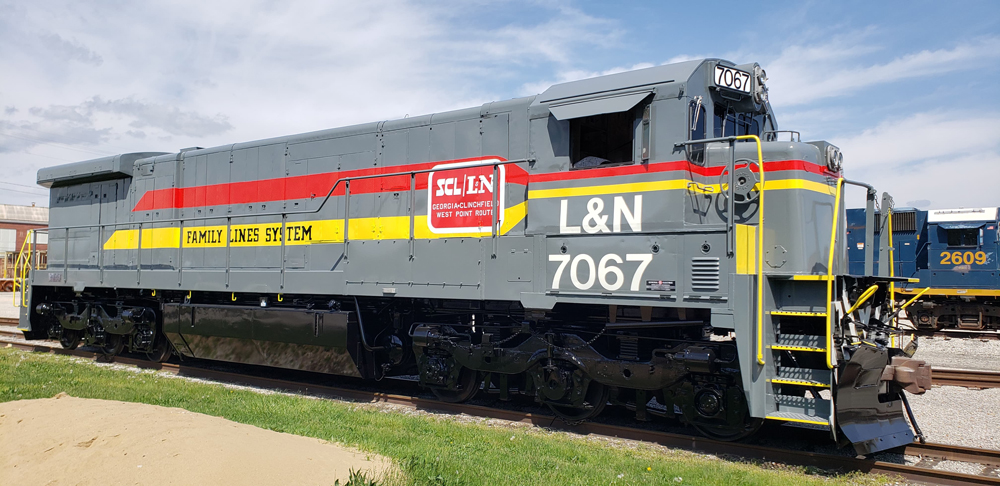 Gray locomotive with red and yellow stripes