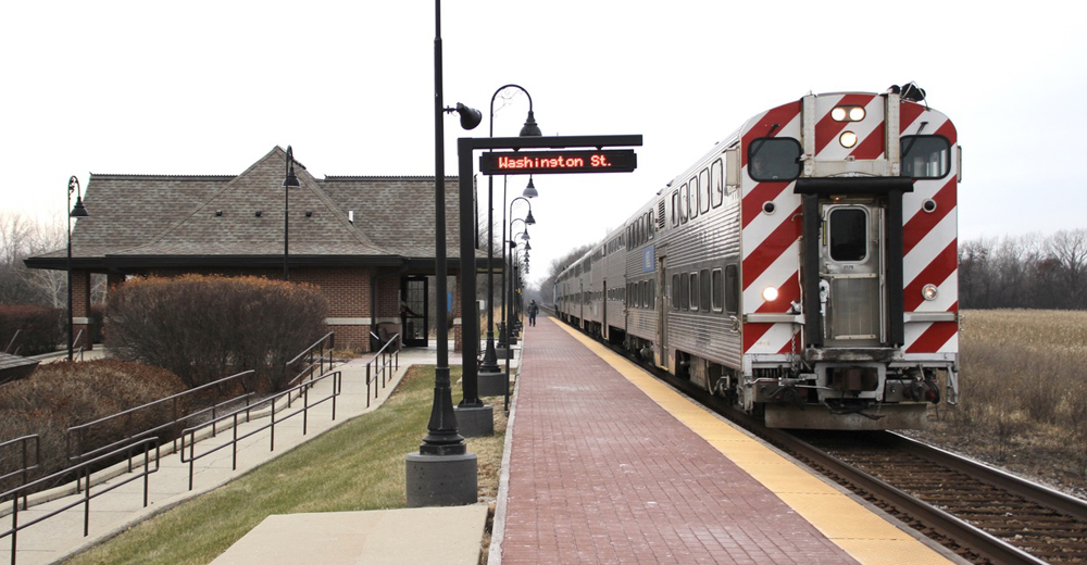 Cab car leads commuter train as it stops at station