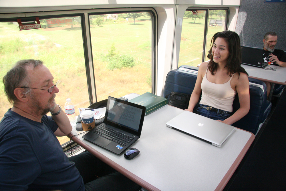 Man and woman at table in passenger car