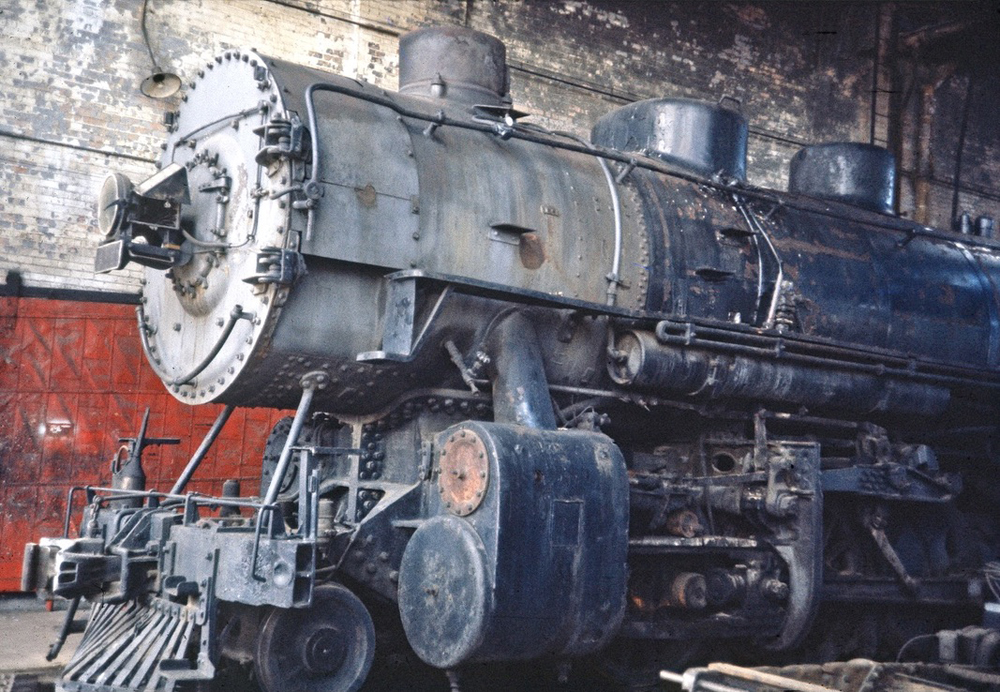 Front of steam locomotive in roundhouse
