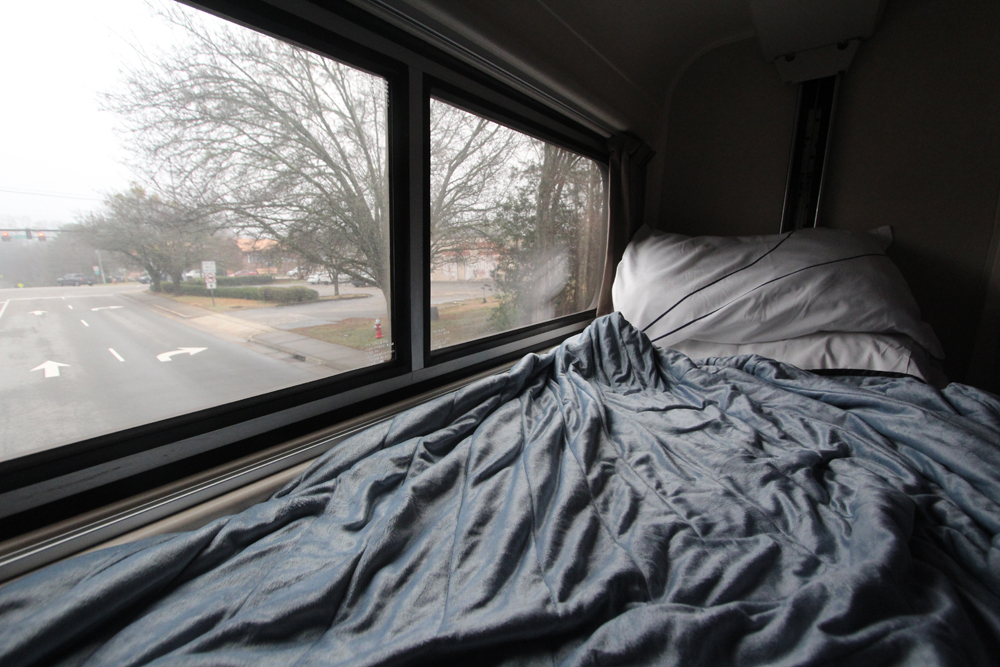 Bed in passenger car next to window
