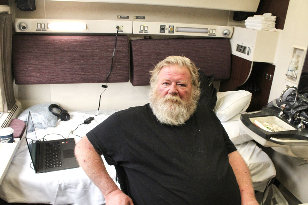 Man in sleeping car bedroom