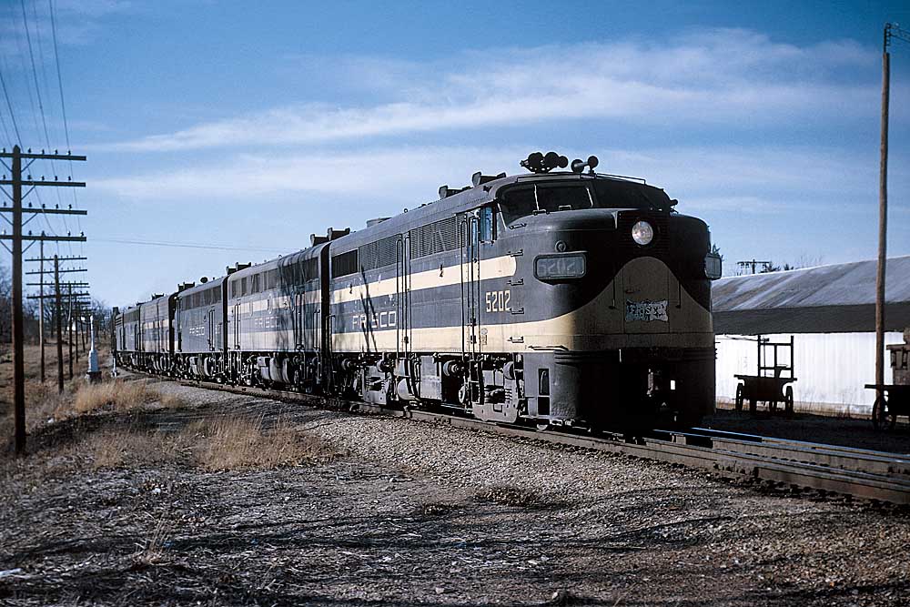 Black and yellow streamlined diesel locomotives on freight train