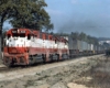 Three red and white diesel locomotives on a Frisco freight train with trailers on flatcars