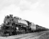 Steam locomotive leads a Frisco freight train with tank cars
