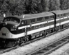 Streamlined diesel locomotive displaying white flags on cab