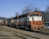 : Red and white diesel locomotives on freight train on curve