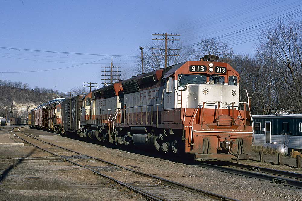 : Red and white diesel locomotives on freight train on curve