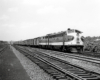 Streamlined locomotives leading a passenger train.