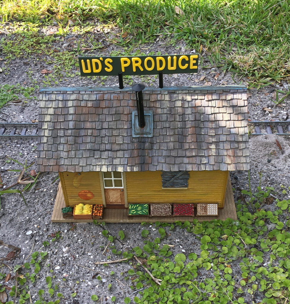 Model produce store on a garden railroad