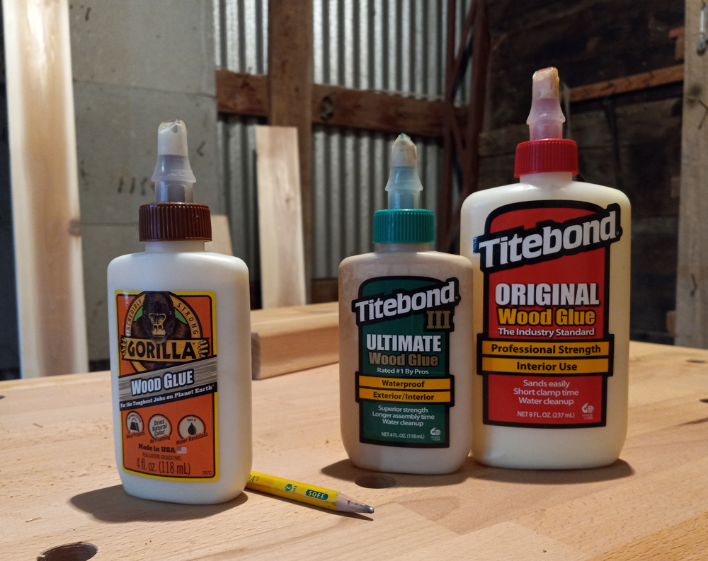 Three bottles of glue on a workbench