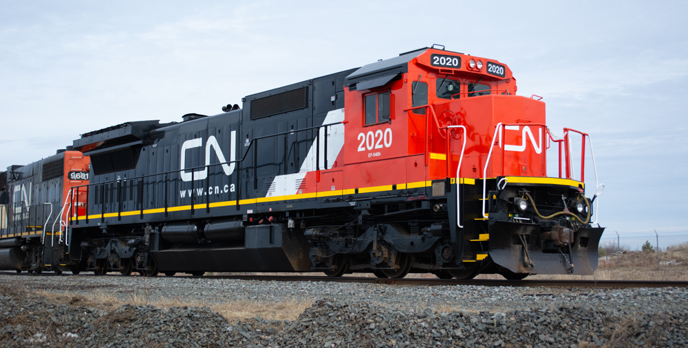 Photo of diesel locomotive painted red, white, and black.