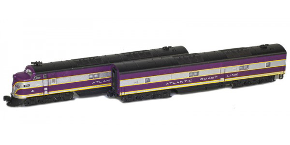 purple, gray, and yellow diesel locomotive