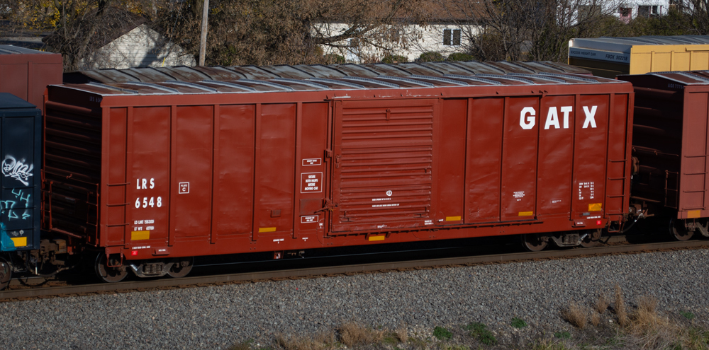 Photo of boxcar painted Oxide Red with white graphics.