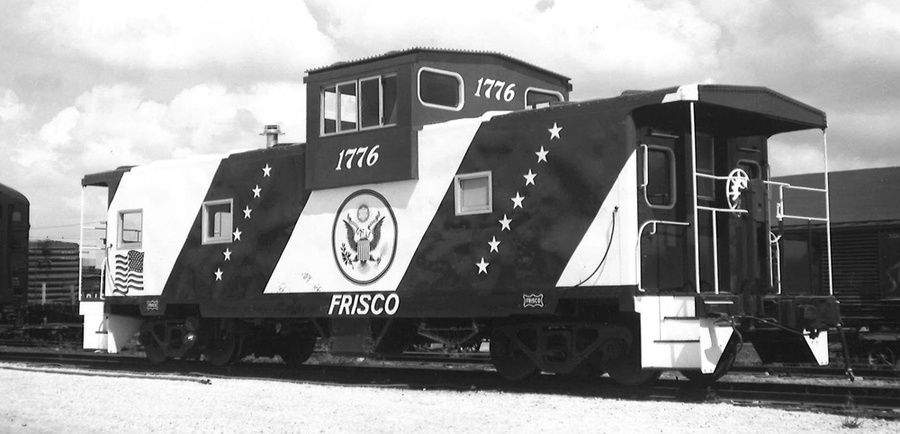 Black-and-white photo of wide-cupola caboose painted for American Revolution Bicentennial.