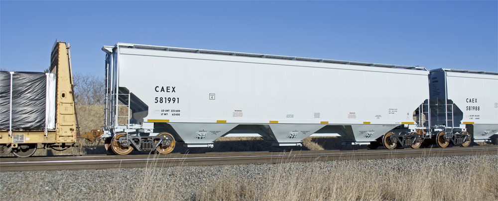 Photo of new three-bay covered hopper painted gray.