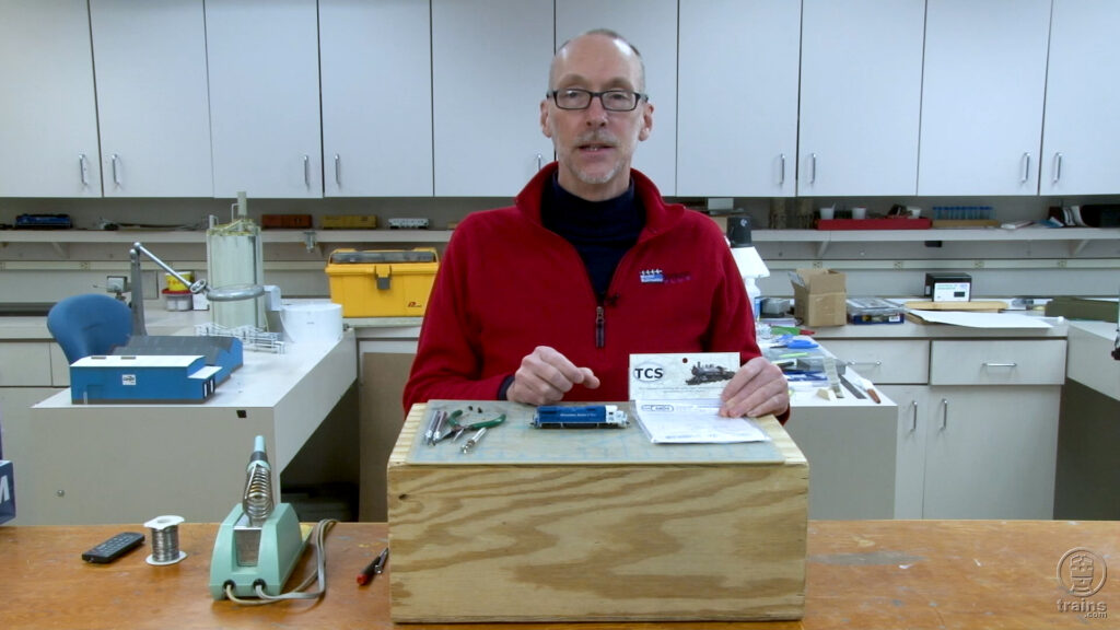 Host David Popp presenting packaged DCC decoder and N scale Atlas diesel locomotive
