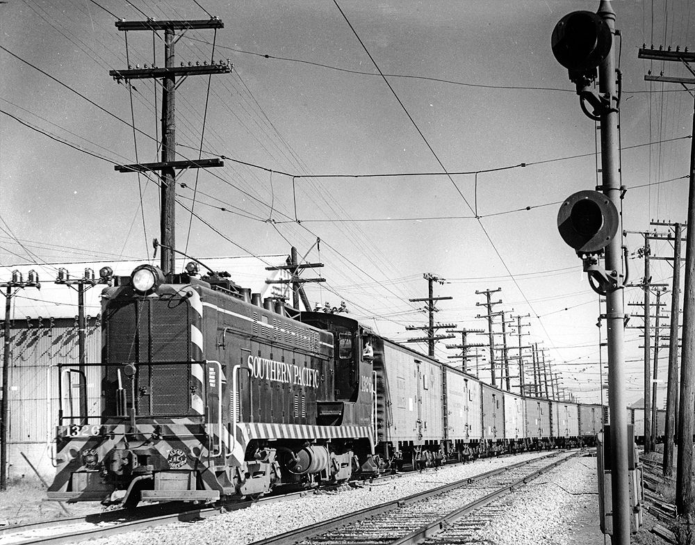Baldwin locomotive with extended carriage post pulling refrigerated cars.