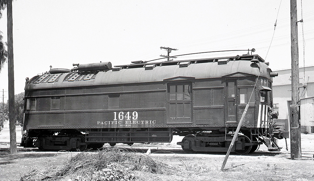 Side view of a modified gas-powered doodlebug with trolley pole.
