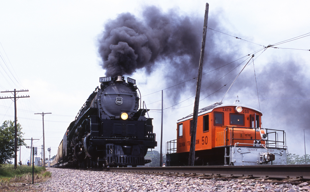 Steam locomotive passes electric locomotive