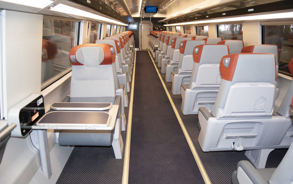 Interior of passenger car with one seat on one side of aisle and two seats on the other