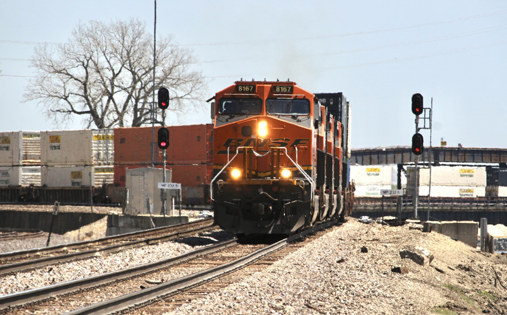 Train with orange locomotives rounds curve