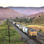 Freight train in valley at dusk